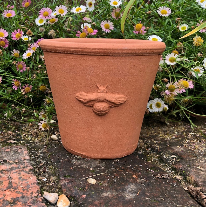 Handmade small terracotta pot with raised decoration. Hand made terracotta flower pot. image 2