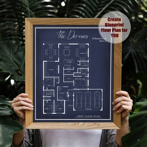 May include: A blueprint floor plan for a house with the name "The Derosas" and the address "101 Blackoak Street, Moore, NC" printed on it. The plan shows the layout of the first floor, including rooms like the living room, kitchen, dining room, family room, master bedroom, and garage.
