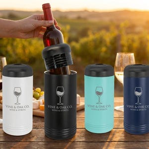 May include: Wine bottle and four insulated wine chillers in white, black, teal, and navy blue. Each chiller has a black lid and a wine glass logo with the text "VINE & OAK CO. WINE & SPIRITS".