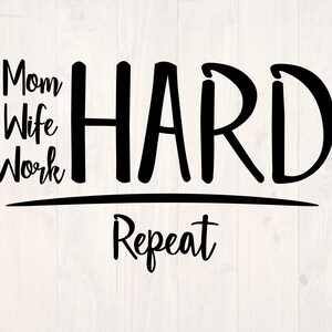 May include: Black and white text graphic that reads "Mom Wife Work Hard Repeat" on a white wood background.
