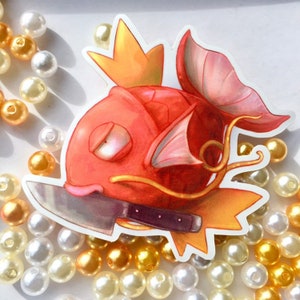 May include: A red and orange cartoon fish with a crown on its head and a knife through its body. The fish is on a white background with white and gold pearls.