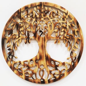 May include: A circular wooden wall decor with a detailed cutout design of a tree of life. The tree has intricate branches and roots, and the wood has a natural, burnt finish.