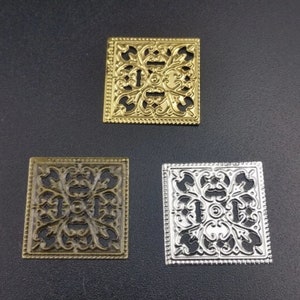 Metal Filigree Ornate Small Tiles. Each pack include 4 tiles. Tiles measure approximately 3/4 inches
