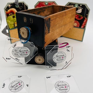 May include: Four clear plastic octagon-shaped rulers with different measurements, including 1/4 inch, 1/2 inch, 3/4 inch, 1.25 inches, 1.5 inches, 1.75 inches, and 2 inches. Each ruler has a circle in the center with the text "Spectrum Art Creations" and a website address.