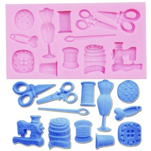 May include: A pink silicone mold with 14 different sewing themed shapes. The shapes include a sewing machine, scissors, spools of thread, buttons, a thimble, a measuring tape, and a dress form. The mold is designed to create edible decorations for cakes and other desserts.