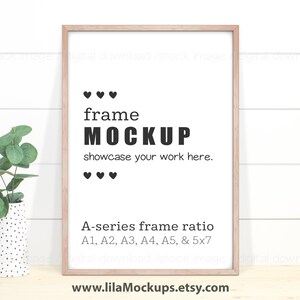 May include: A light wood frame mockup with a white background. The frame is on a white wood plank wall. The text "frame MOCKUP" is in black text. The text "showcase your work here." is in black text. The text "A-series frame ratio A1, A2, A3, A4, A5, & 5x7" is in black text. There are three small hearts above and below the text "frame MOCKUP".