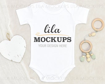 baby bodysuit Mockup PHOTO - simple blank baby bodysuit mock up / baby bodysuit flatlay PHOTO / simple white blank baby bodysuit Stock Photo