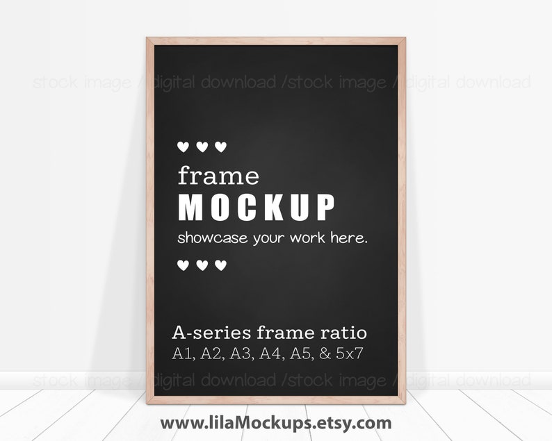 May include: A black frame mockup with a white wooden frame. The frame is on a white wood floor and a white wall. The text on the frame reads "frame MOCKUP showcase your work here." and "A-series frame ratio A1, A2, A3, A4, A5, & 5x7".