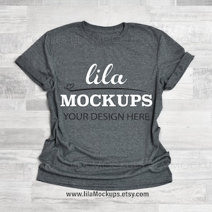 May include: A heather gray t-shirt mockup with the text "lila MOCKUPS YOUR DESIGN HERE" printed on the front.