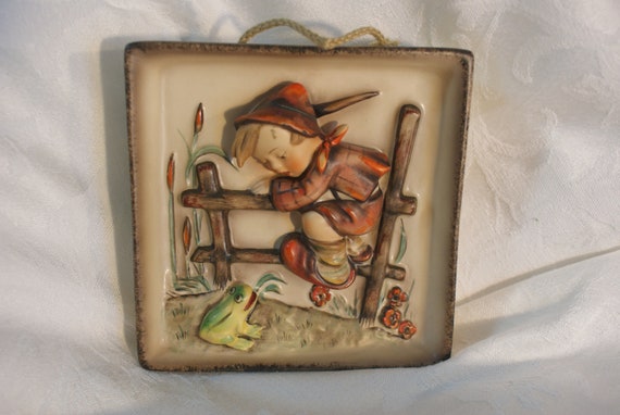 hummel boy on fence with frog