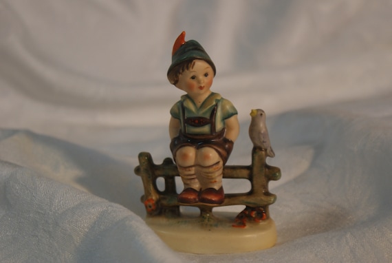 hummel boy on fence with bird