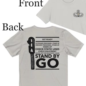 May include: A set of three ceramic mugs with a speckled, matte finish. The mugs are in shades of cream, light gray, and dark gray. Each mug has a simple, minimalist design and a rounded handle. The mugs are likely for coffee or tea.