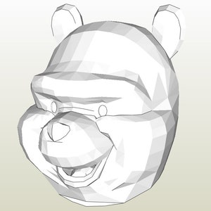 May include: A white, low-poly 3D model of a bear's head. The bear has a smiling expression, with visible teeth and a small nose. The ears are rounded, and the eyes are represented by small, circular indents. The model appears to be a papercraft or a digital design.