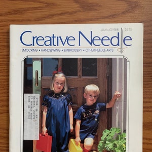 May include: A magazine cover for Creative Needle, a publication for needle arts. The cover features two children, a girl in a blue dress and a boy in a blue and white shirt, standing in front of a wooden door. The magazine title is in large, bold letters and the issue date is July/August 1988.