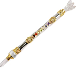 May include: A silver and gold wand with a clear crystal tip and a clear crystal point at the top. The wand is decorated with seven gemstones in different colors, representing the seven chakras.