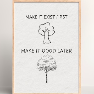 May include: A framed print with the text "MAKE IT EXIST FIRST" above a simple tree illustration and "MAKE IT GOOD LATER" above a detailed tree illustration. The frame is a light brown color.