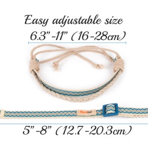 May include: A beige and blue adjustable dog collar with a sliding buckle. The collar is made of rope and fabric and has a zig-zag pattern. The collar is adjustable from 6.3 to 11 inches (16 to 28 cm) and 5 to 8 inches (12.7 to 20.3 cm).