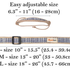 May include: A beige and blue patterned dog collar with a black buckle and a silver ring. The collar is adjustable and comes in three sizes: small (10-15.5 inches), medium (13-20 inches), and large (18-26 inches).
