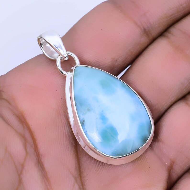 May include: A teardrop-shaped pendant with a blue and white gemstone set in sterling silver.