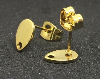 May include: A pair of gold-tone earring studs with a teardrop-shaped design. The earrings have a post and butterfly backing.