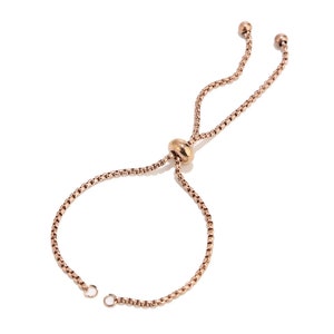 May include: A rose gold adjustable bracelet with a sliding knot closure. The bracelet is made of a delicate chain.