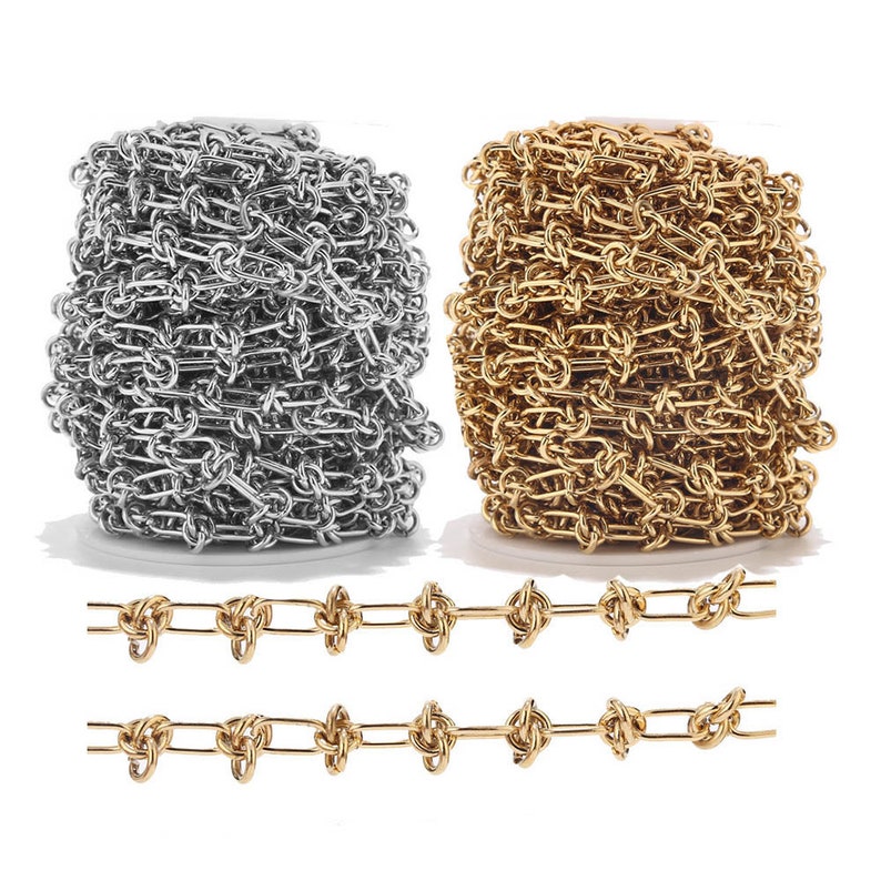 May include: Two spools of chain, one silver and one gold, with a close-up of the gold chain in a straight line.