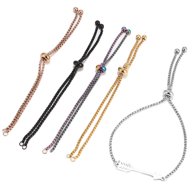 May include: Five adjustable bracelets with different colored chains and beads. The bracelets have a sliding clasp and are made of metal. One bracelet has an arrow charm.