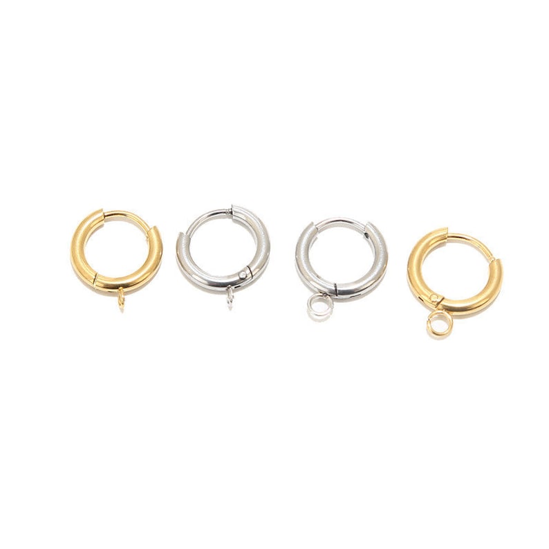May include: Four hoop earrings with a jump ring. Two are gold, two are silver.