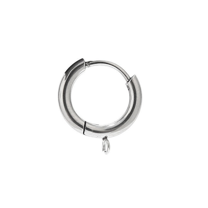 May include: Silver hoop earring with a hinged clasp and a small dangling charm.