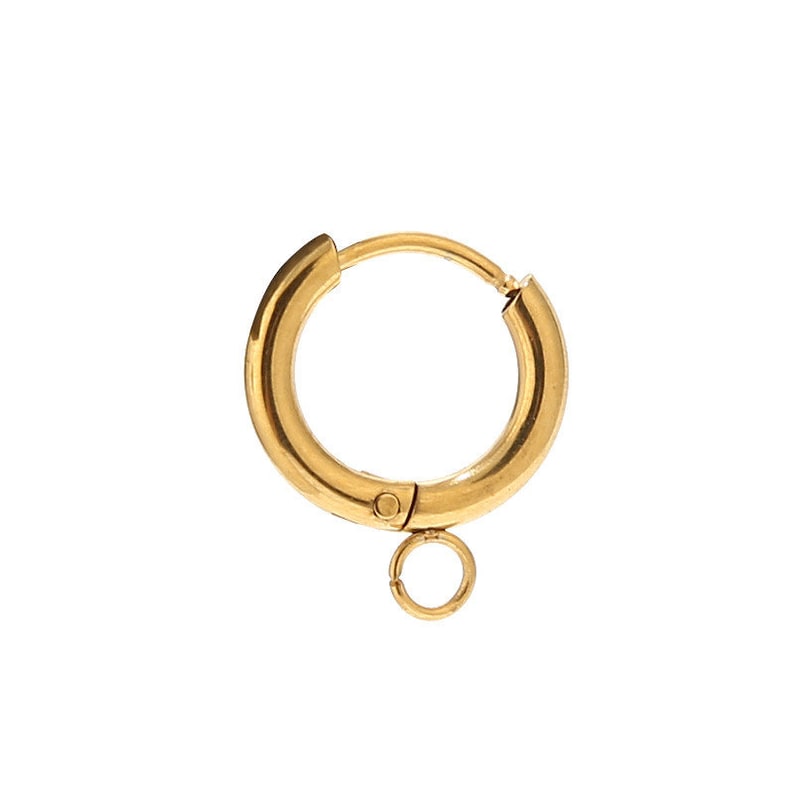 May include: Gold hoop earring with a small jump ring attached. The hoop is hinged and has a click closure.