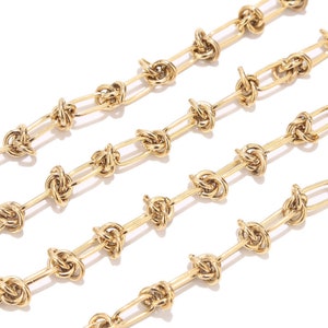 May include: A gold chain necklace with a knotted design. The chain is made of small, oval-shaped links that are connected by knots.