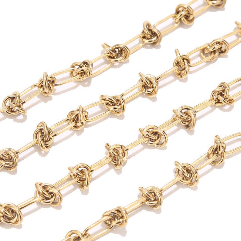 May include: A gold chain necklace with a knotted design. The chain is made of small, oval-shaped links that are connected by knots.