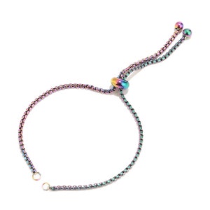 May include: A rainbow colored adjustable bracelet with a sliding bead and two small beads at the end of the ties.