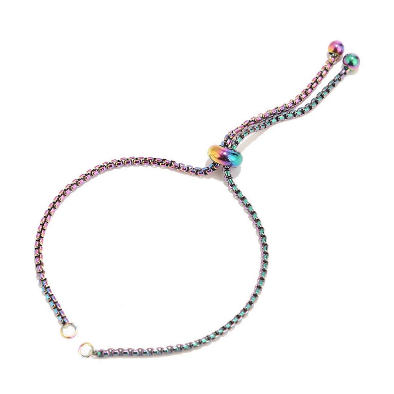 May include: A rainbow colored adjustable bracelet with a sliding bead and two small beads at the end of the ties.