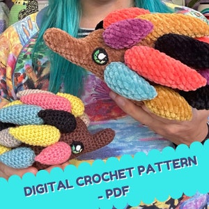 May include: Two colorful crocheted amigurumi animals, one brown with multi-colored spikes and one brown with multi-colored spikes, with the text "DIGITAL CROCHET PATTERN - PDF" on a blue background.