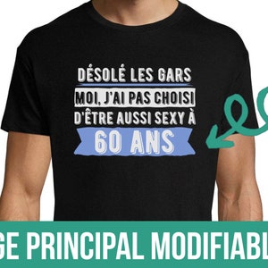 Peut inclure: T-shirt noir avec du texte blanc qui dit "DÉSOLÉ LES GARS MOI, J'AI PAS CHOISI D'ÊTRE AUSSI SEXY À 60 ANS". Le texte est entouré d'une bannière bleue. Le texte "ÂGE PRINCIPAL MODIFIABLE" est en bas de l'image.