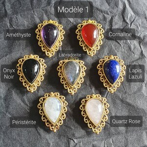 May include: Model 1 of gemstone pendants in gold settings. Amethyst, carnelian, onyx, labradorite, lapis lazuli, moonstone, and rose quartz.
