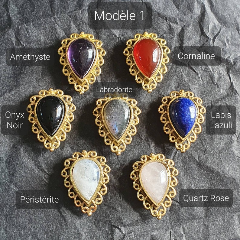 May include: Model 1 of gemstone pendants in gold settings. Amethyst, carnelian, onyx, labradorite, lapis lazuli, moonstone, and rose quartz.