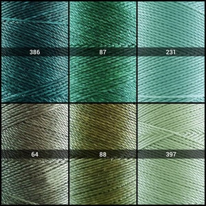 May include: Six spools of thread in various shades of green and gray. The spools are labeled with numbers: 386, 87, 231, 64, 88, and 397.