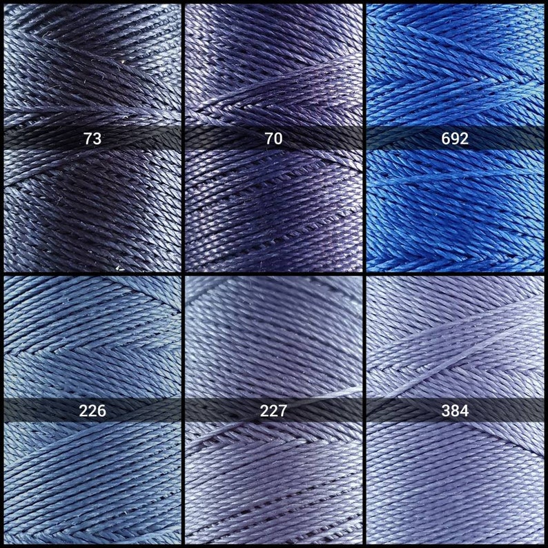 May include: Nine spools of thread in various shades of blue. The spools are labeled with numbers: 73, 70, 692, 226, 227, and 384.