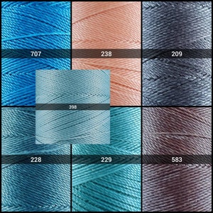 May include: A collection of spools of thread in various shades of blue, pink, gray, and brown. The spools are labeled with numbers: 707, 238, 209, 398, 228, 229, and 583.