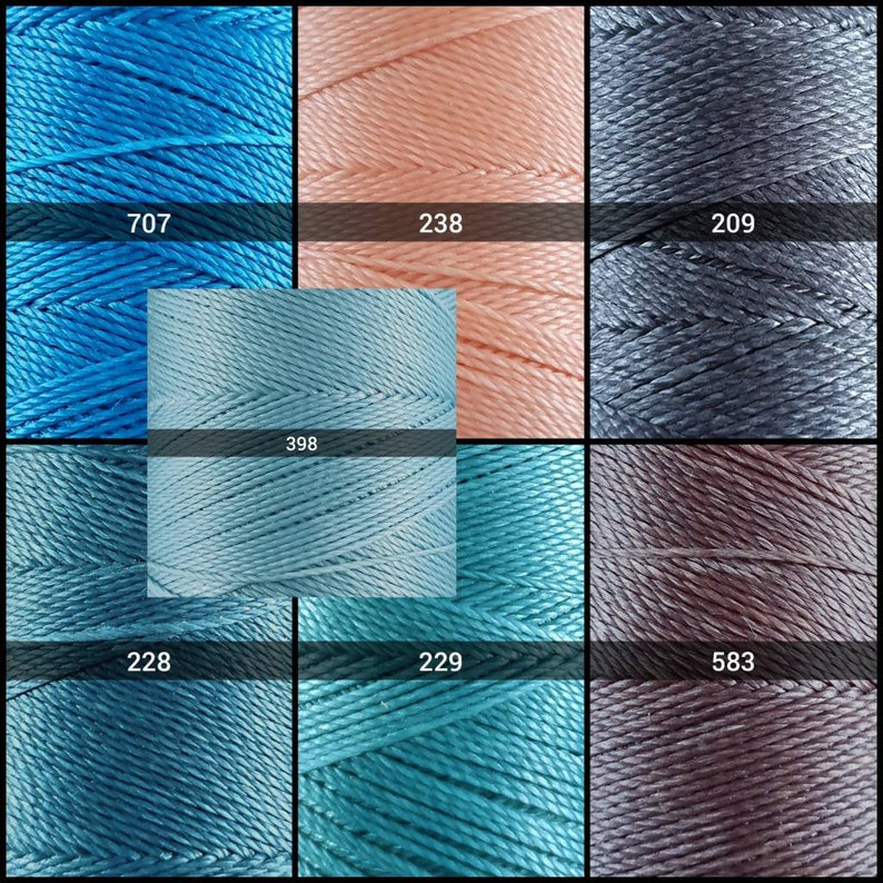 May include: A collection of spools of thread in various shades of blue, pink, gray, and brown. The spools are labeled with numbers: 707, 238, 209, 398, 228, 229, and 583.