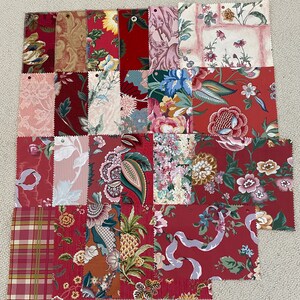 May include: A collection of 20 fabric swatches featuring various floral patterns in shades of red, pink, and white. The swatches are arranged in a grid pattern and are perfect for quilting, sewing, or crafting projects.