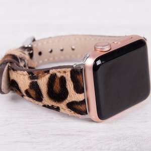 May include: A rose gold Apple Watch with a leopard print leather band.