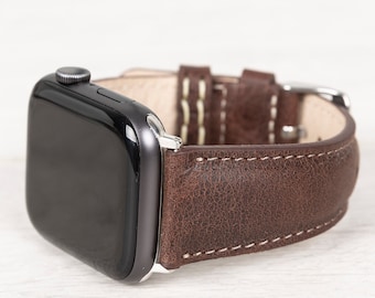 May include: A brown leather watch band with white stitching for an Apple Watch.