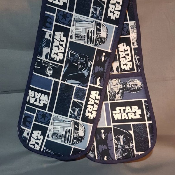 Double oven gloves in cotton print.  Star Wars characters in  blue  and white with navy blue trim.