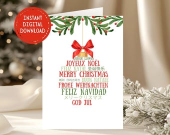 May include: A white card with a green and red watercolor illustration of a Christmas bell with a red bow. The card features the text "Merry Christmas" in English, along with the phrase in several other languages, including French, Spanish, German, Italian, and Japanese.