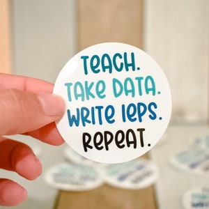 May include: A white round sticker with blue and teal text that reads "Teach. Take Data. Write IEPs. Repeat."