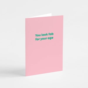 May include: Pink card with the text "You look fab for your age" in green.