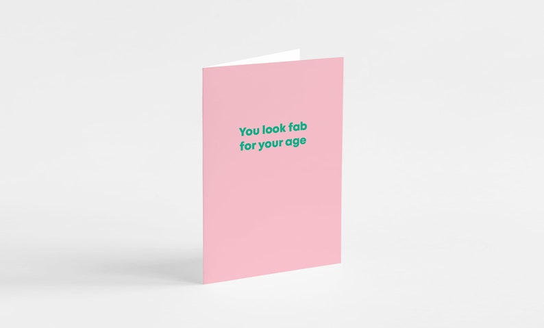 May include: Pink card with the text "You look fab for your age" in green.